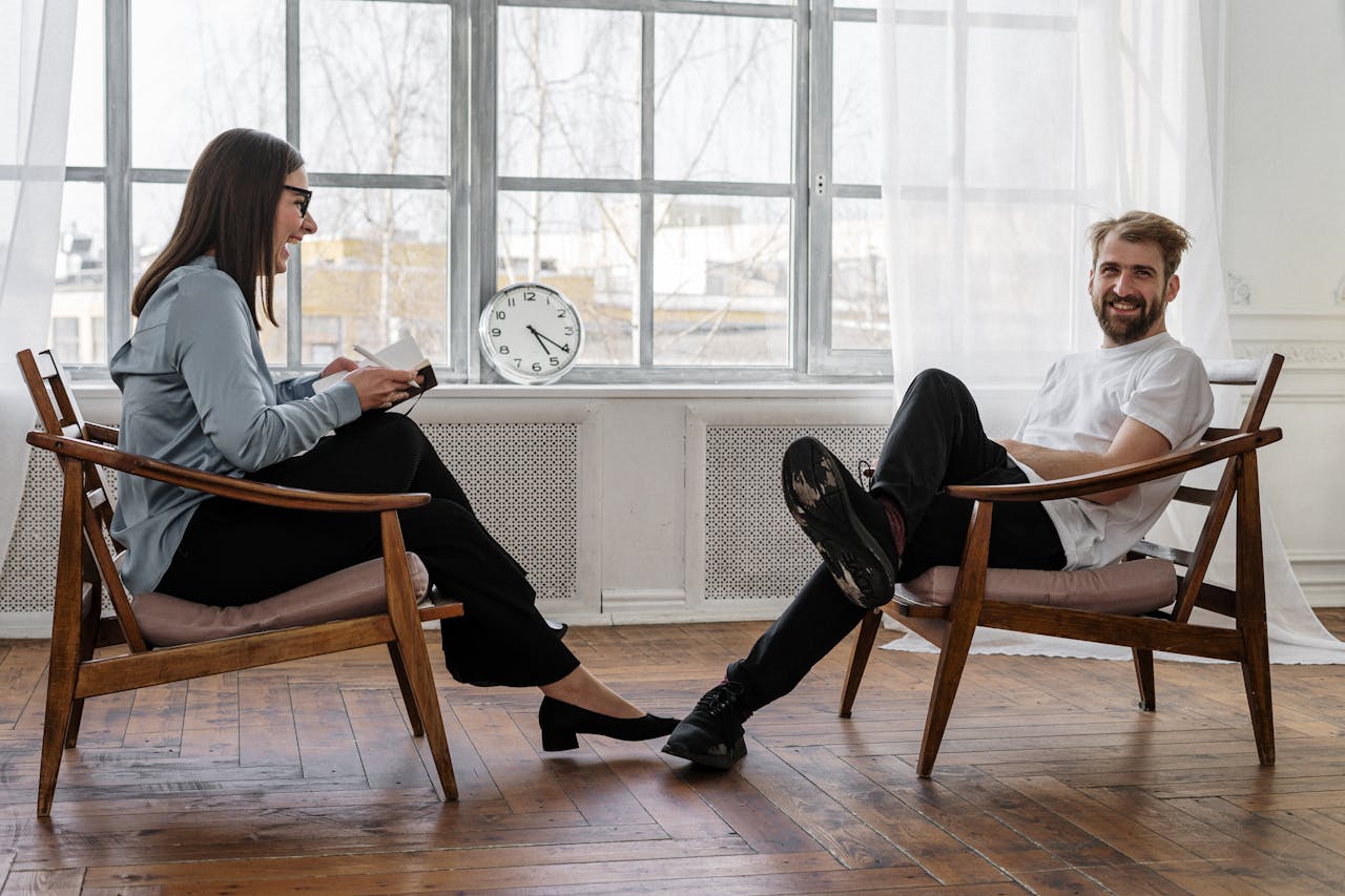 collection-03 Counselor and client in a positive therapy session in a well-lit room.